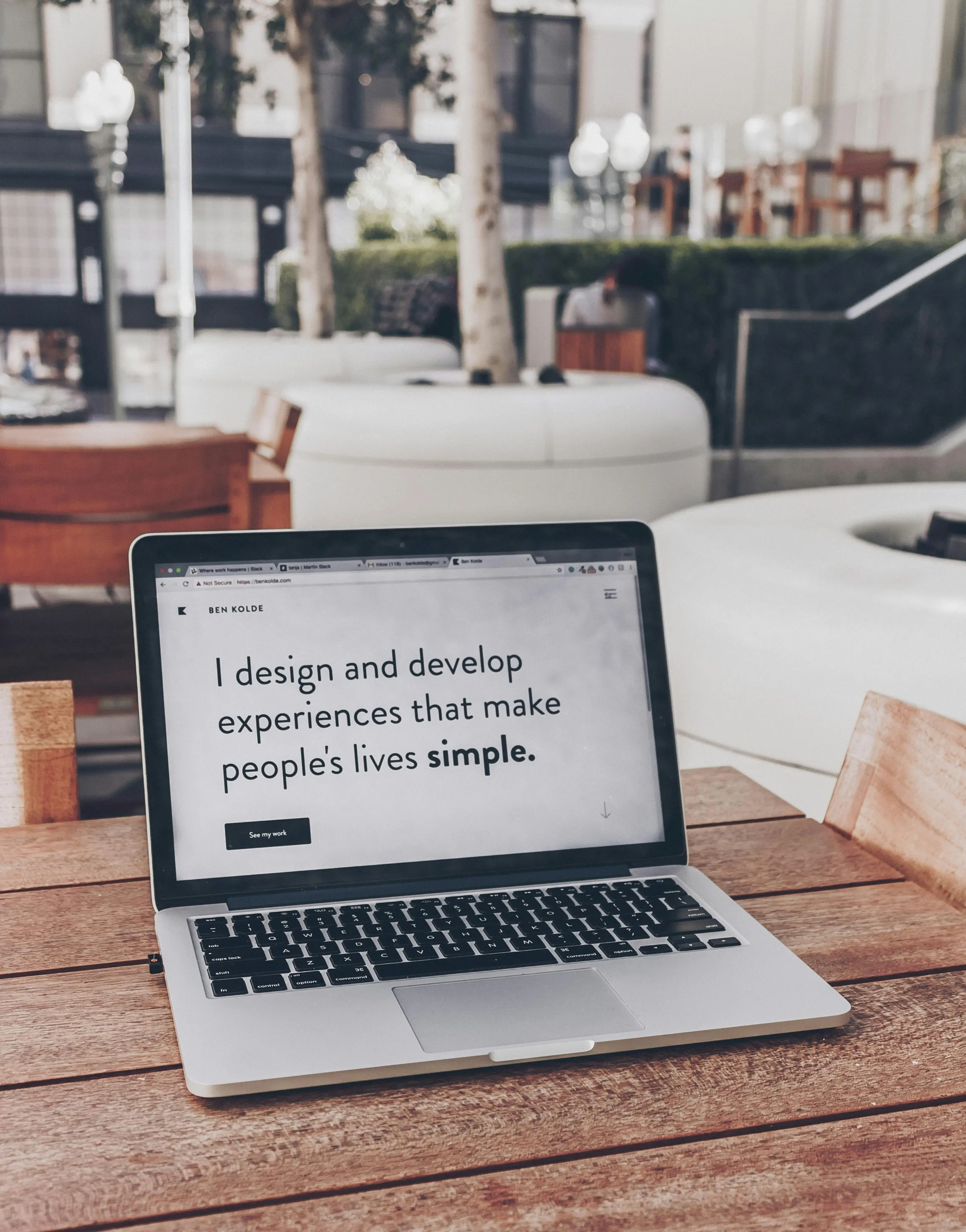 laptop with quote on screen saying: I design and develop experiences that make people's live simple